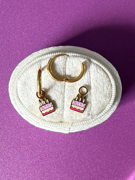 Birthday cake charm hoops on oval white velvet jewelry box Showing enamel colors and open hoop