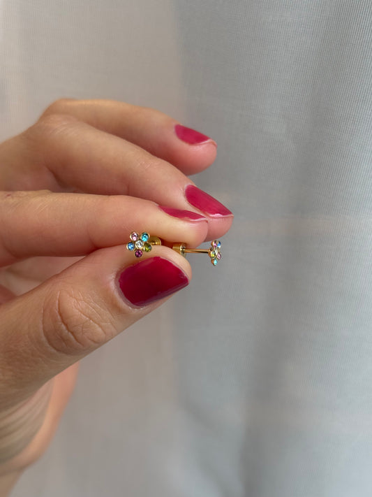 Colorful Flower Crystals Studs Being held between 2 adult fingers to show screwbacks and sparkle details