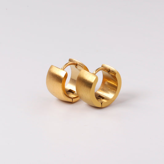 Gold hoop earrings on a light gray background