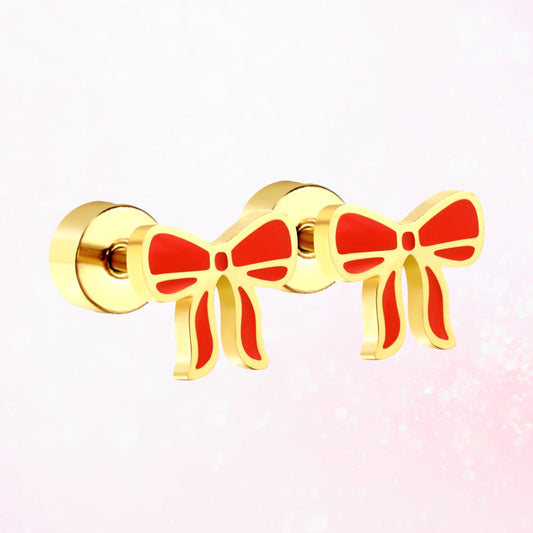 Pair of red and gold studs with flat screw-back backings on a sparkly faint pink back.