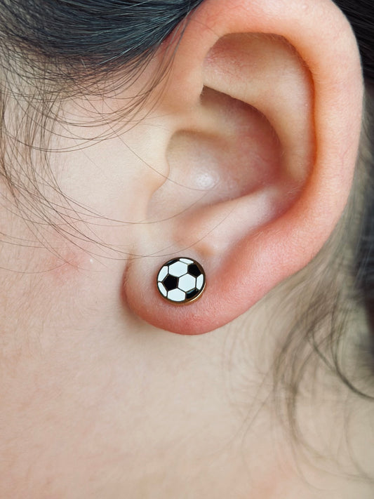 Soccer ball studs shown being worn on a kids ear