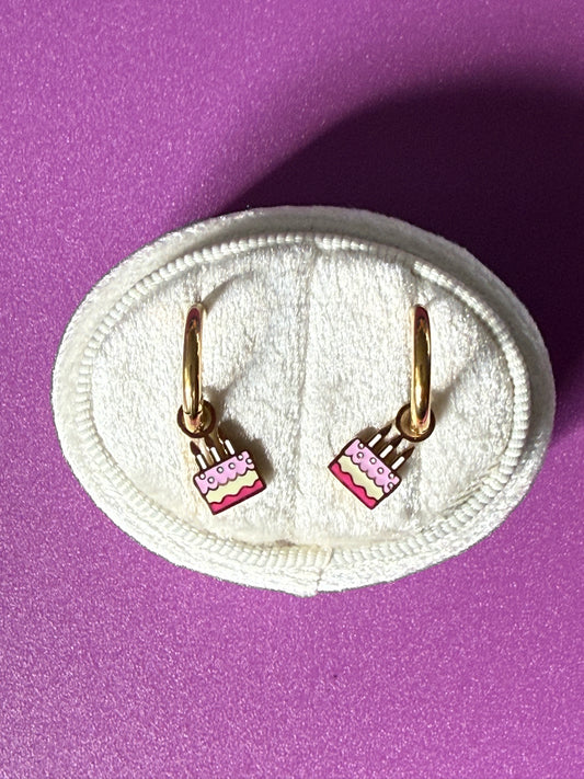 Birthday cake charm hoops on oval white velvet jewelry box