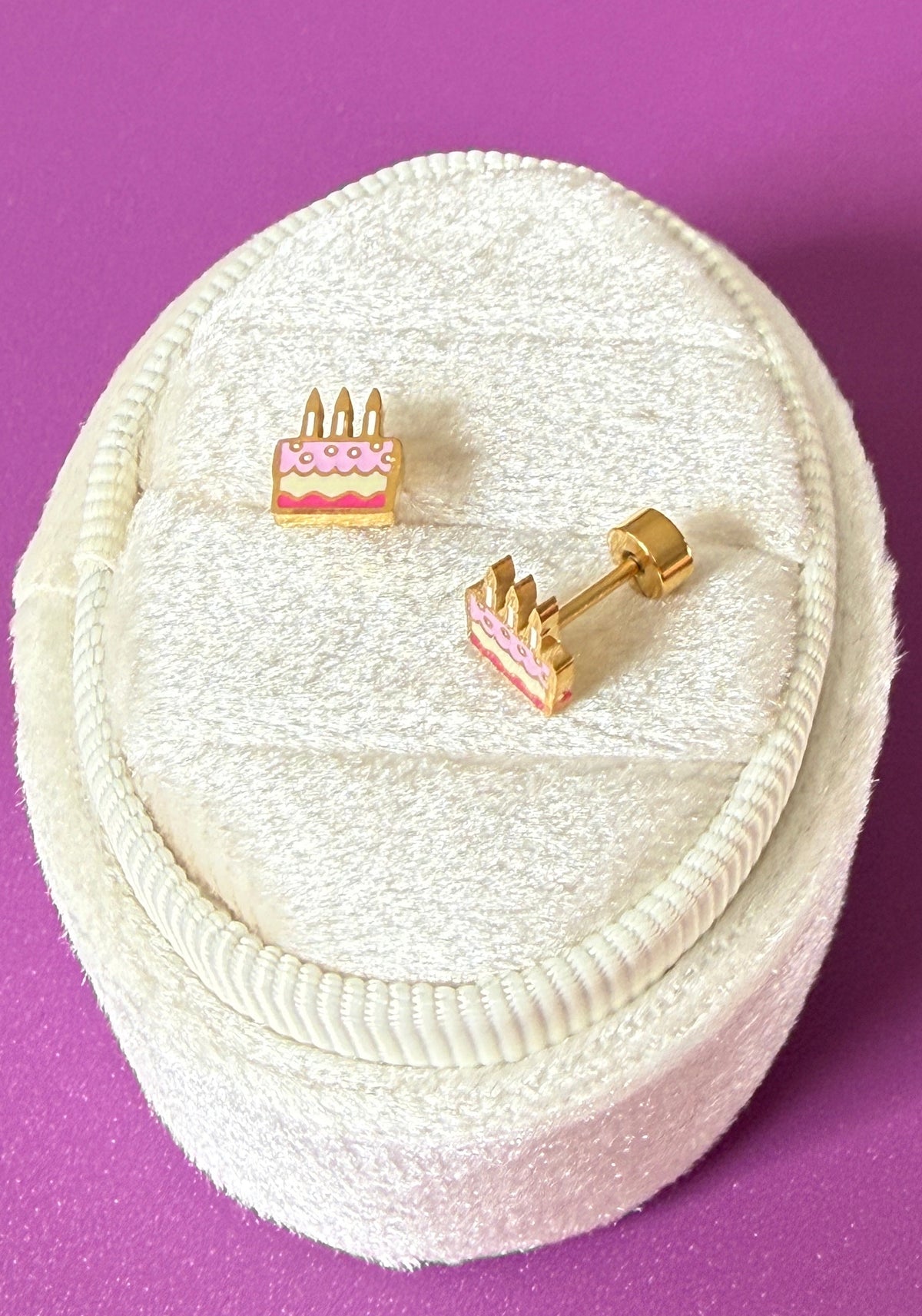 Birthday cake studs On white velvet jewelry box showing screwback detail and enamel colors