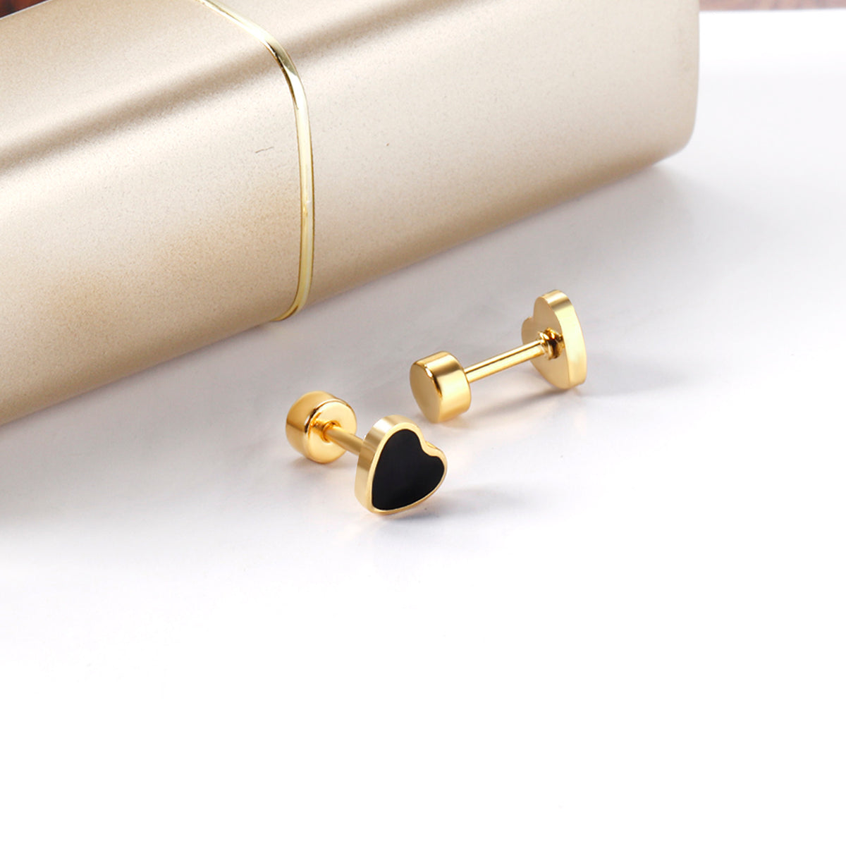 Black and Gold Heart Studs Shown on white backdrop, showing detail of flat Screwbacks