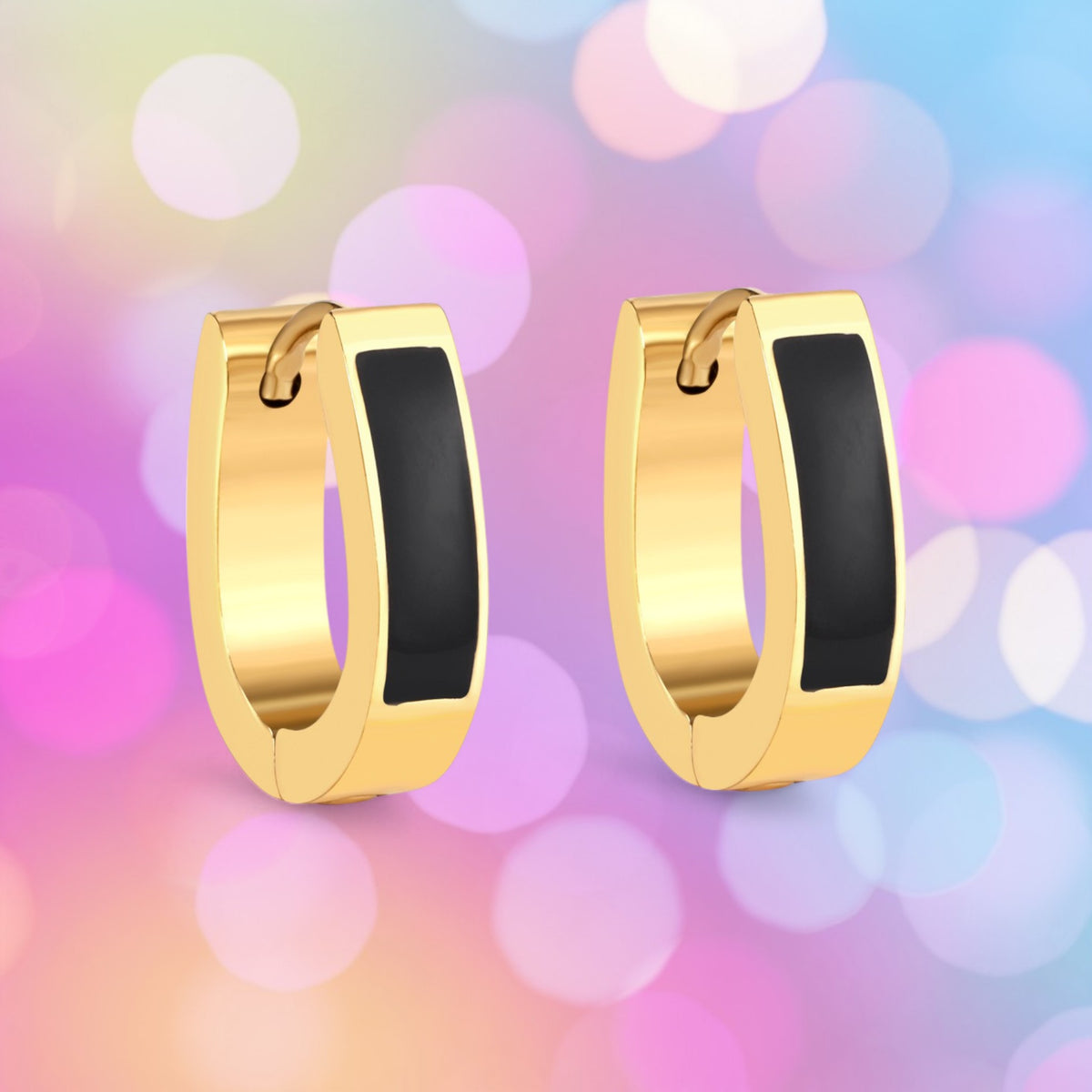 A pair of black and gold enamel strip hoop earrings on a colorful bokeh background.