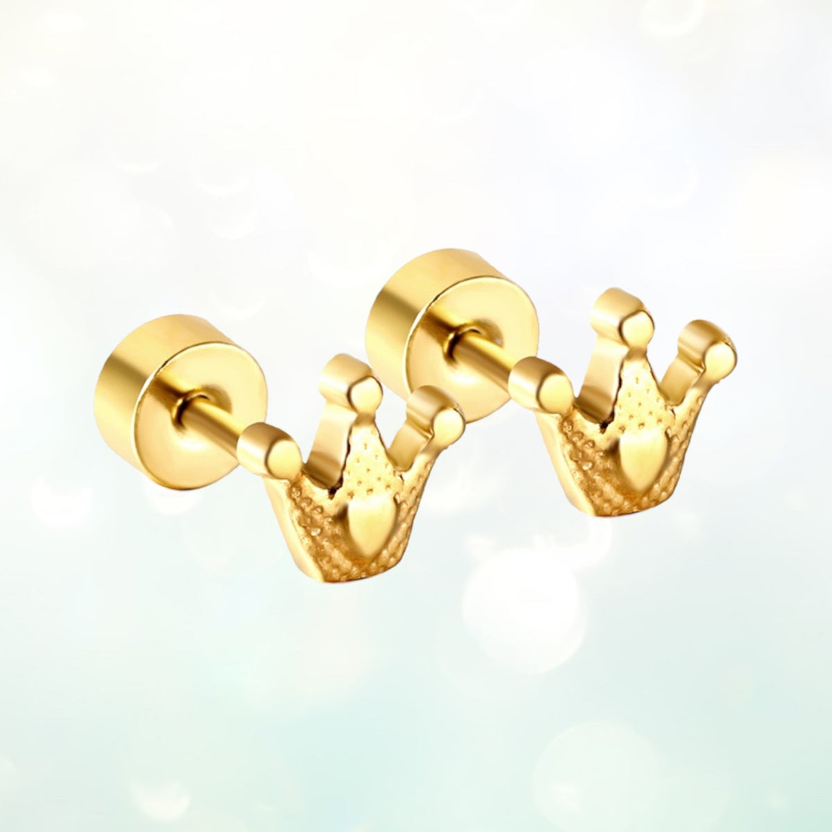 A pair of gold-colored princess crown earrings with a flat back and screw-back closure, displayed against a blurred background.